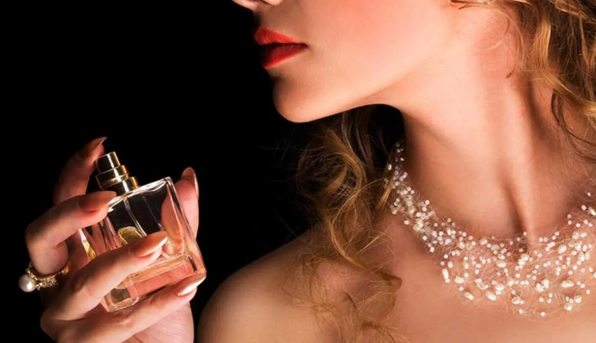 female holding perfume bottle